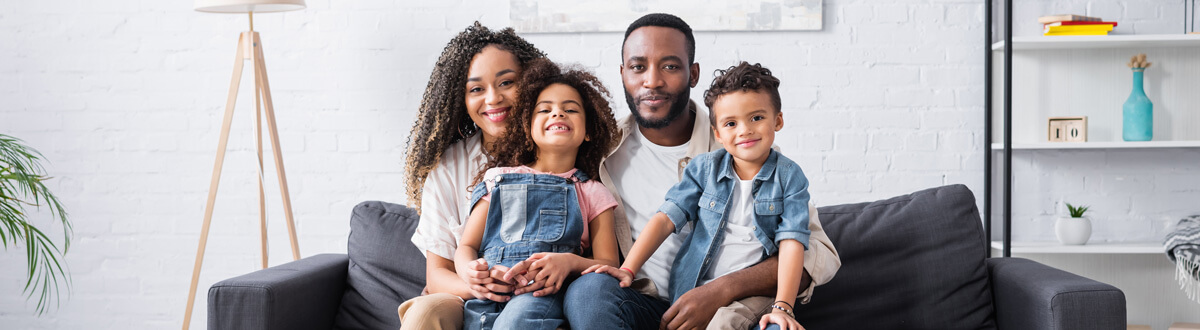 Family smiling together at home